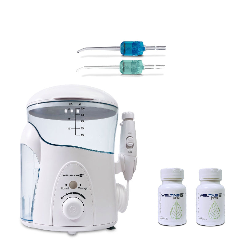 A white oral irrigator water flosser with a clear reservoir, shown with two Weltips blue and seafoam plus two small white bottles labeled Weltab on a plain white background.