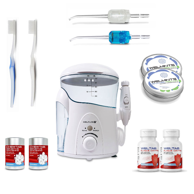 A white oral irrigator water flosser set with a clear water tank, handpiece, toothbrush,  blue Weltip, clear Weltip, a small red-and-white bottle,  an aluminum container with mints, and a white-and-red bottle on a plain white background.